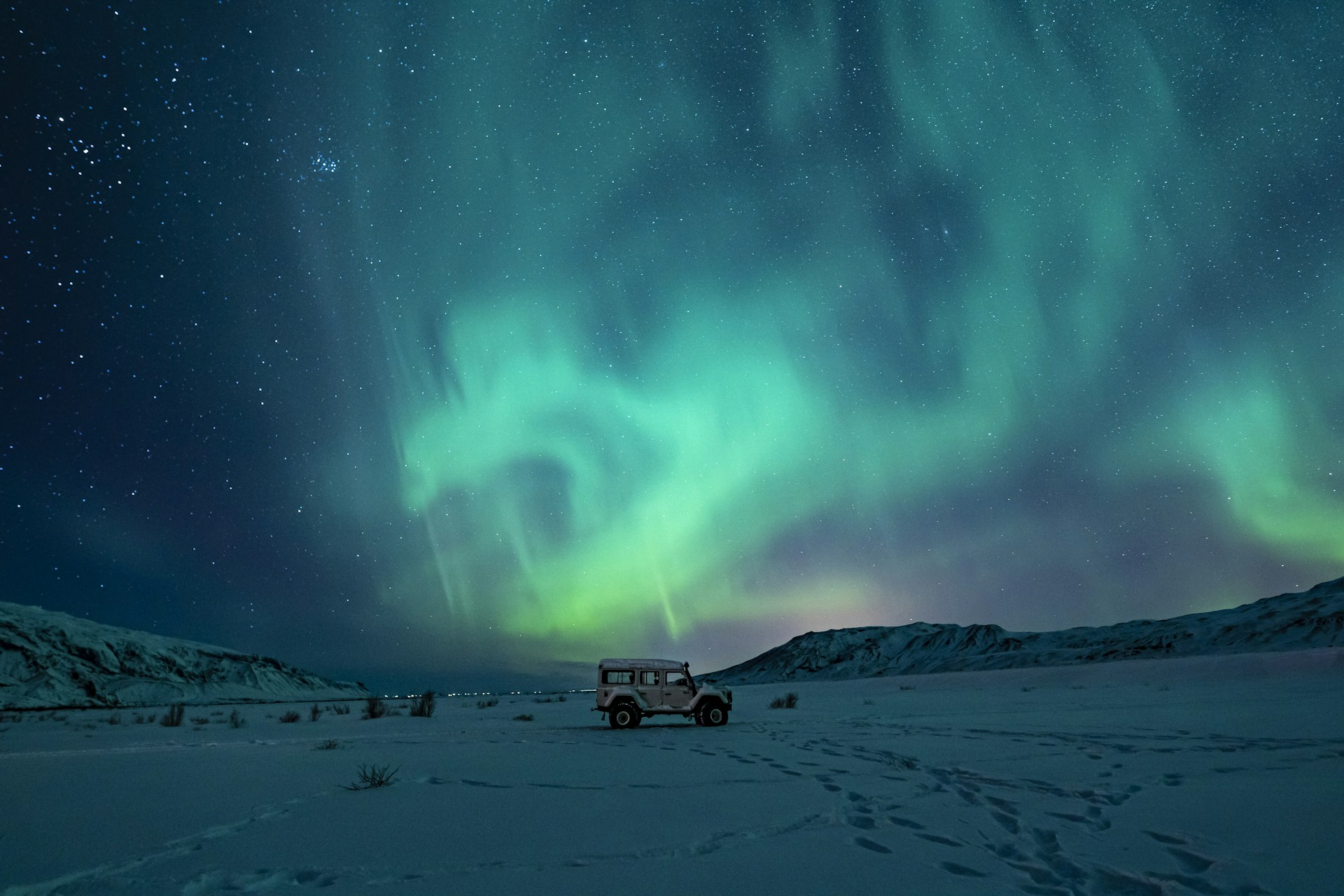 Iceland - Northern Lights - SUV parked on snow